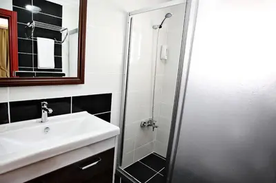 a bathroom with a sink and a shower at Taksim Palace Hotel in Istanbul