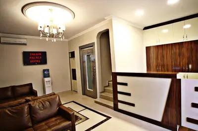a living room with a couch and a kitchen at Taksim Palace Hotel in Istanbul