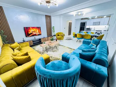 a living room with a blue couch and yellow furniture at Sisli Holiday 231 in Istanbul