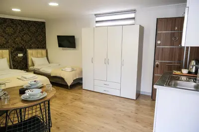 a room with a kitchen and a living room at Taksim Neo Pera Suites in Istanbul