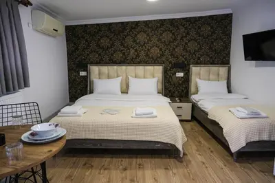 a bedroom with two beds and a table with plates on it at Taksim Neo Pera Suites in Istanbul