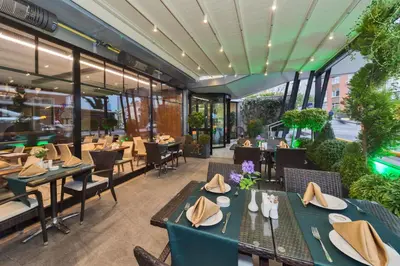 an empty restaurant with tables and chairs and tablesktop at Hotel Boursier 1 & Spa in Istanbul