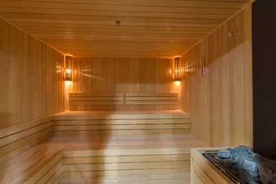 a sauna with wood paneling and lights on the wall at Hotel Boursier 1 & Spa in Istanbul