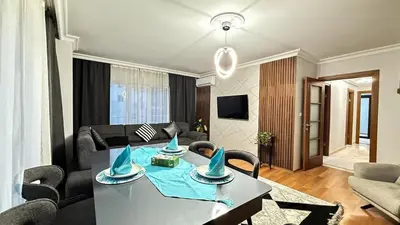 a living room with a table and a couch at Bomenti Sisli in Istanbul