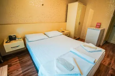 a bedroom with a bed with two towels on it at Sahra Otel in Istanbul