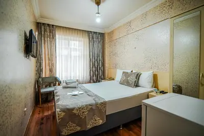 a small room with a bed and a window at Sahra Otel in Istanbul