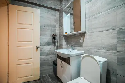 a bathroom with a toilet and a sink and a mirror at Sahra Otel in Istanbul