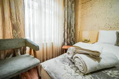 a small room with a bed and a window at Sahra Otel in Istanbul