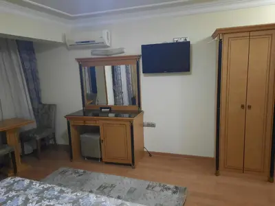 a room with a mirror and a cabinet and a tv at GRAND HiSAR HOTEL in Istanbul