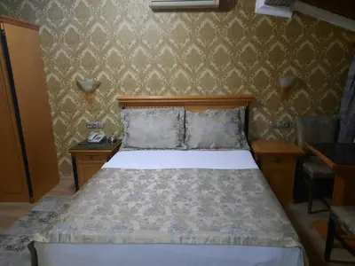 a bedroom with a bed and two nightstands and a bed sidx sidx sidx at GRAND HiSAR HOTEL in Istanbul