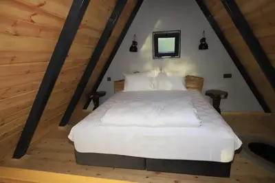 a bedroom with a white bed in a attic at Köyevi Teras Bungolov in Kartepe