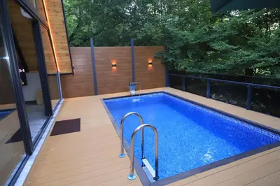 a swimming pool on the deck of a house at Köyevi Teras Bungolov in Kartepe