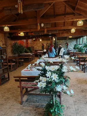 a group of tables with white flowers in a restaurant at Köyevi Teras Bungolov in Kartepe