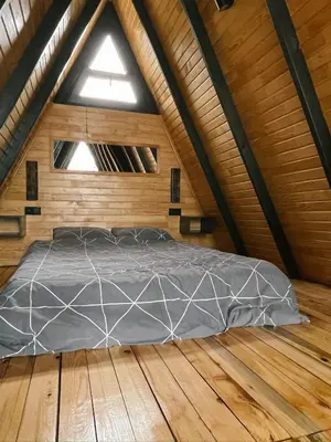 a bed in a room with a wooden floor at Wolf house in Sapanca