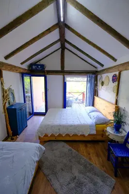 a bedroom with two beds and a ceiling with beams at Aknadağevi sapanca in Sapanca