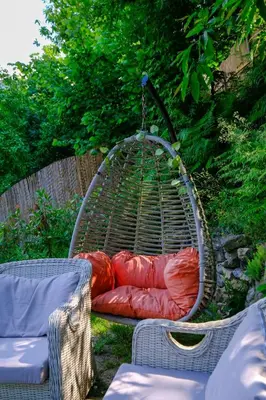 a bird cage with red sleeping bags in it at Aknadağevi sapanca in Sapanca