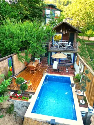a backyard with a swimming pool and a deck with a house at Aknadağevi sapanca in Sapanca