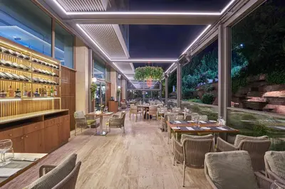a restaurant with tables and chairs and windows at DoubleTree by Hilton Hotel Istanbul - Tuzla in Istanbul