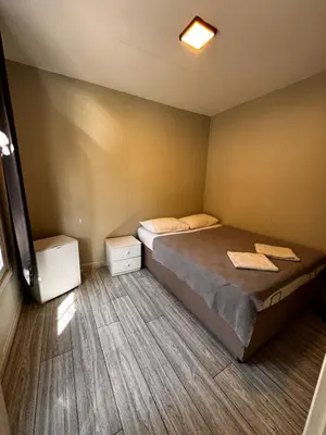 a bedroom with a bed and two night stands at Ali Baba Butik Otel in Gündoğdu
