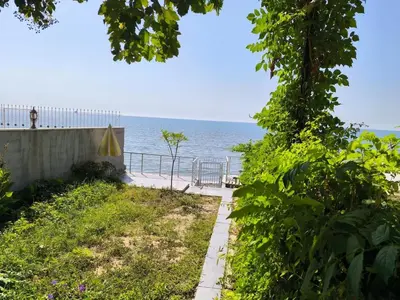 a path to the beach with an umbrella and the ocean at Villa Taskoparan in Tekirdag