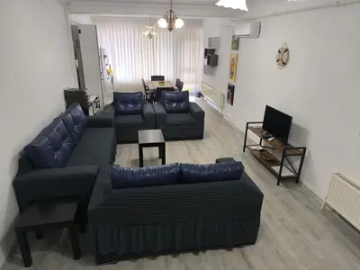 a living room with two couches and a television at Villa Taskoparan in Tekirdag
