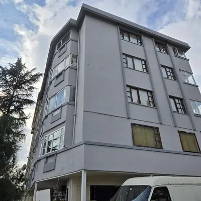 a tall white building with a van parked in front of it at Haliç Konaklama in Istanbul