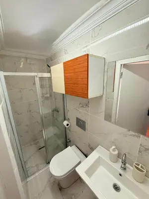 a bathroom with a toilet and a shower and a sink at Haliç Konaklama in Istanbul