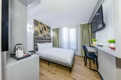 a hotel room with a bed and a desk at Dedem Hotel Premium - Çorlu in Corlu