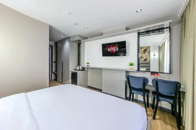 a hotel room with a table and chairs at Dedem Hotel Premium - Çorlu in Corlu