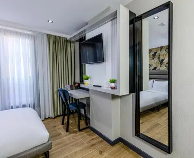 a hotel room with a bed and a desk at Dedem Hotel Premium - Çorlu in Corlu