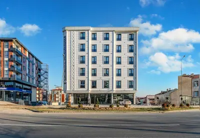 a white building on the side of a street at Dedem Hotel Premium - Çorlu in Corlu