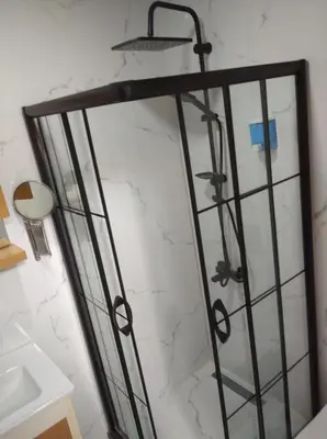 a shower in a bathroom with a marble wall at mars hotel in Istanbul