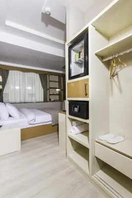a small bedroom with two beds and a tv at mars hotel in Istanbul