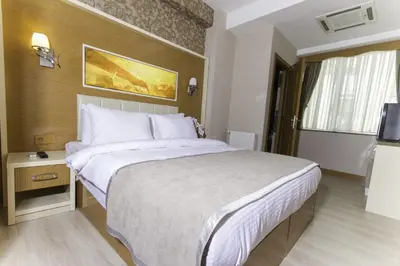 a hotel room with a large bed and a television at mars hotel in Istanbul