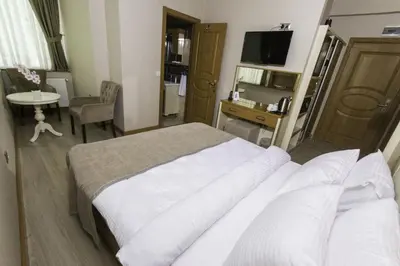 a hotel room with a large bed and a desk at mars hotel in Istanbul