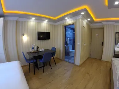 a room with a table and chairs and a bedroom at Meydan Suites in Istanbul