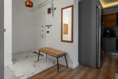 a stool in a room with a white wall at Luxury Scandinavian Design 2BR Duplex Near Tomtom in Istanbul