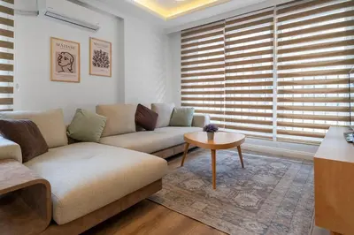 a living room with a couch and a table at Luxury Scandinavian Design 2BR Duplex Near Tomtom in Istanbul