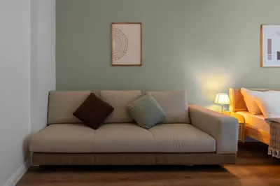 a living room with a couch with pillows on it at Luxury Scandinavian Design 2BR Duplex Near Tomtom in Istanbul
