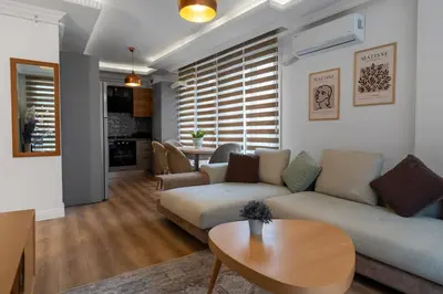 a living room with a couch and a table at Luxury Scandinavian Design 2BR Duplex Near Tomtom in Istanbul