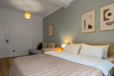 a bedroom with a large bed and a couch at Luxury Scandinavian Design 2BR Duplex Near Tomtom in Istanbul