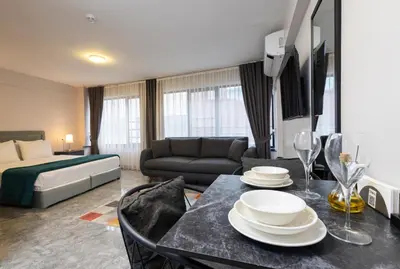 a living room with a bed and a dining room table at Obishu in Istanbul