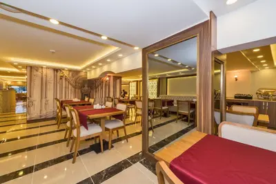 a restaurant with tables and chairs and a dining room at Marmara Place Old City Hotel in Istanbul