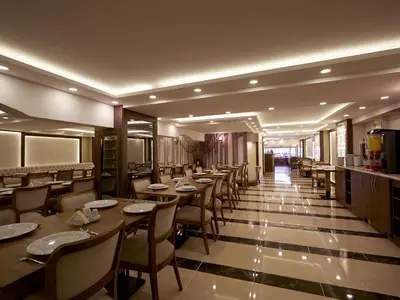 a restaurant with tables and chairs in a room at Marmara Place Old City Hotel in Istanbul