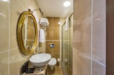 a bathroom with a sink and a mirror at Marmara Place Old City Hotel in Istanbul