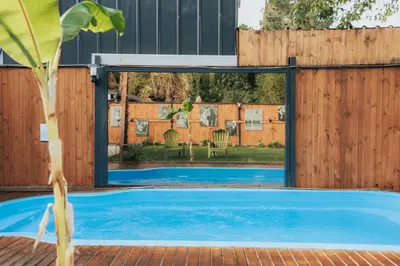 an external view of a swimming pool with a wooden fence at The Jungle Sapanca in Sakarya
