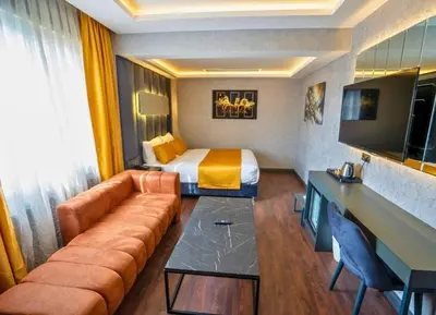a hotel room with a couch and a bed at 216 Silver Suite in Tuzla