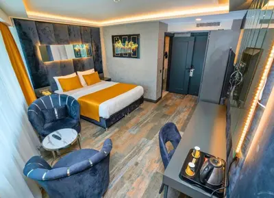 a hotel room with a bed and a table and chairs at 216 Silver Suite in Tuzla