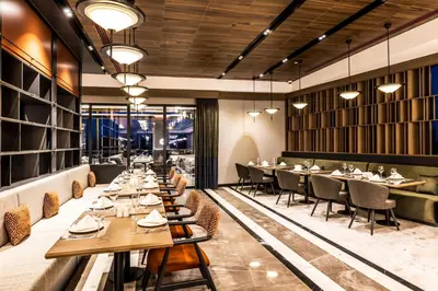 a dining room with tables and chairs in a restaurant at GOLDEN TULIP GEBKIM KOCAELI in Kocaeli