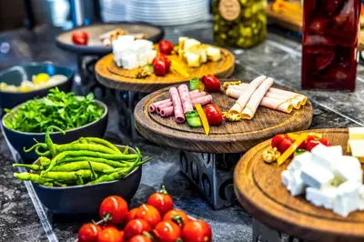 a bunch of vegetables on wooden plates on a table at GOLDEN TULIP GEBKIM KOCAELI in Kocaeli